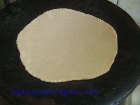 Cook chapati in a pan on medium flame.